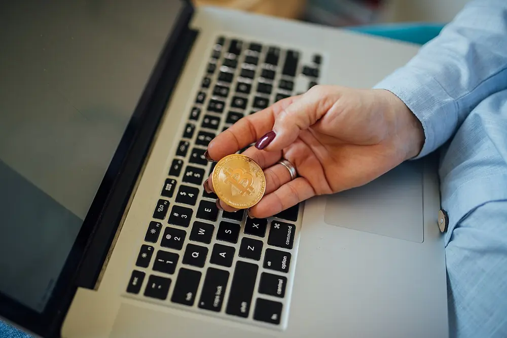 how to deposit usdt at cloudbet canada - physical bitcoin coin held in a hand