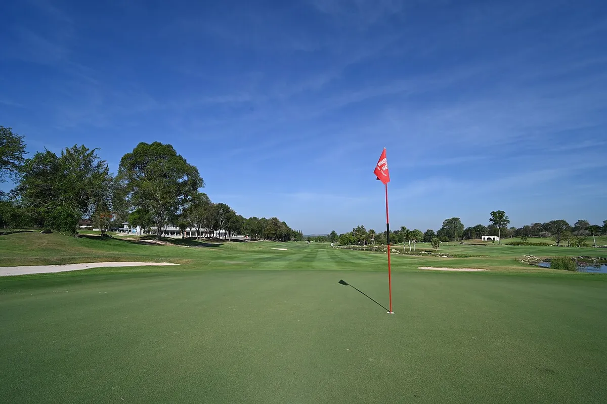 golf green with flag on a calm day