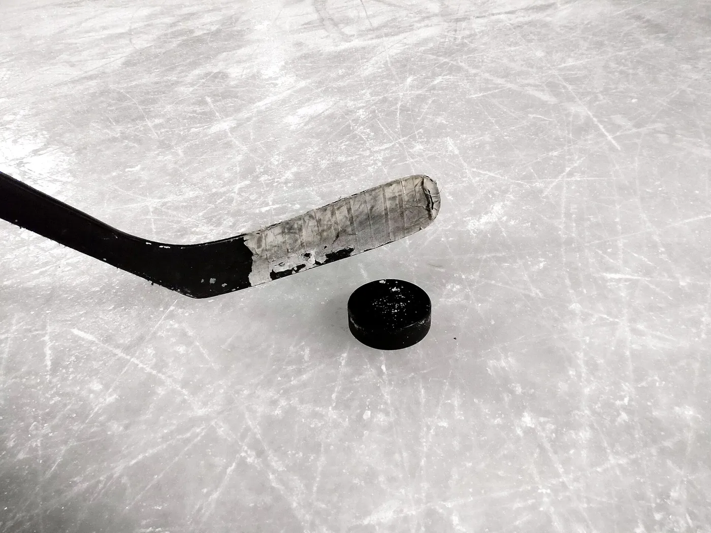 ice hockey stick and puck on the ice