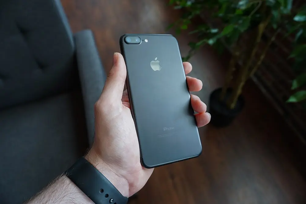 Black smartphone in hand - affiliate disclosure